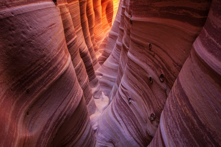 The first time I visited this little slot in Escalante, my buddy Jeremy was walking behind me when a large moqui ball fell out of the cliff wall above him. It just barely missed his head by a few inches. It just shows you never know when rocks are going to fall! You can see the pock marks from old moqui balls on the right.